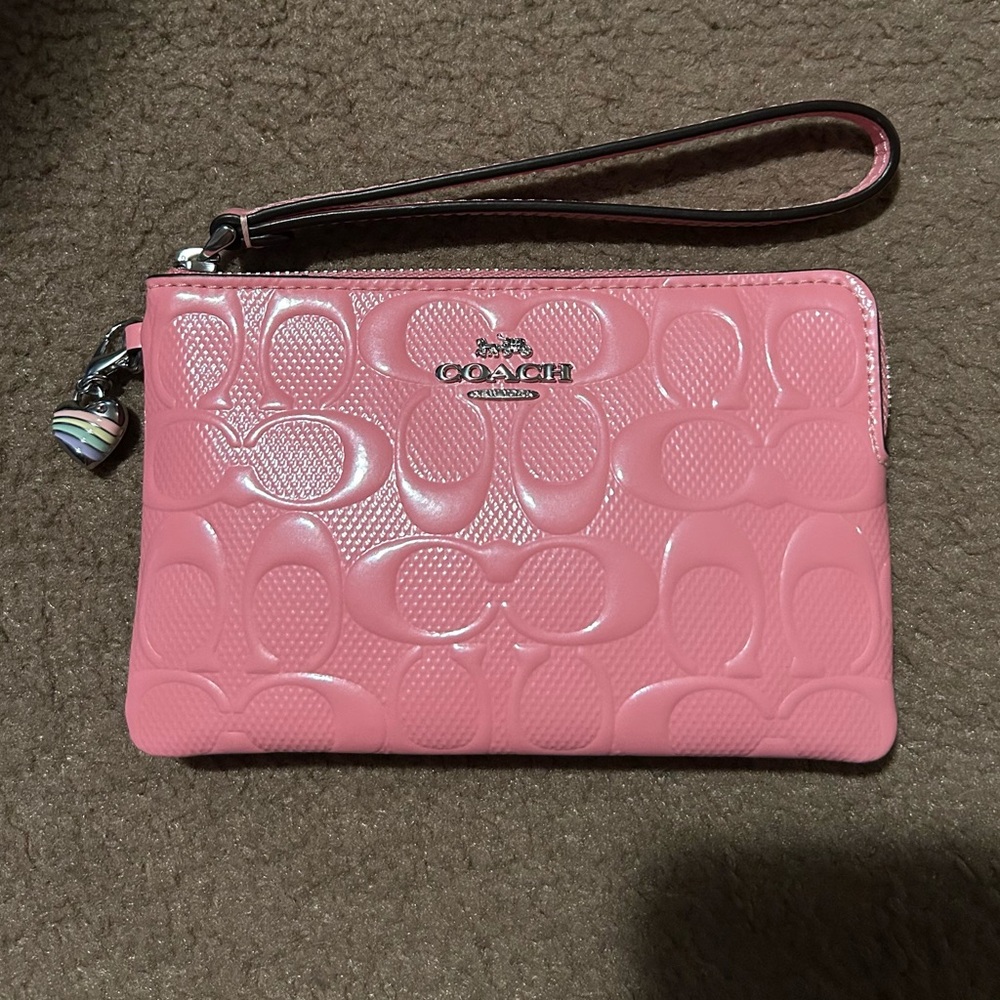 Coach Corner Zip Wristlet
In Signature Leather Pink With Heart Charm